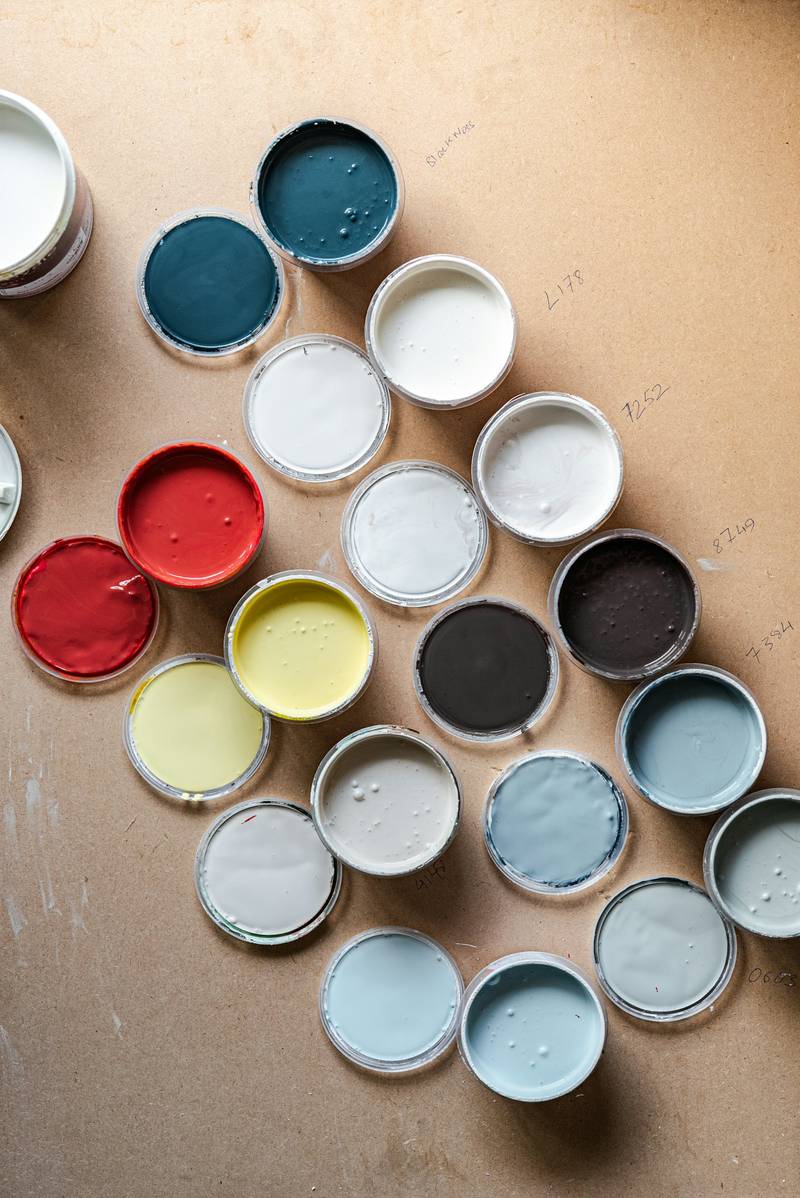 Sample pot lids in muted colors laid out on a board. Reference photograph.
