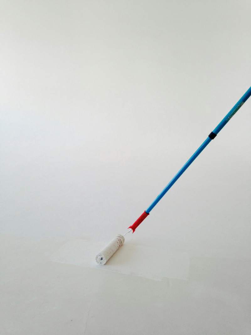 A single roller stroke on a plain white wall. Reference photograph.